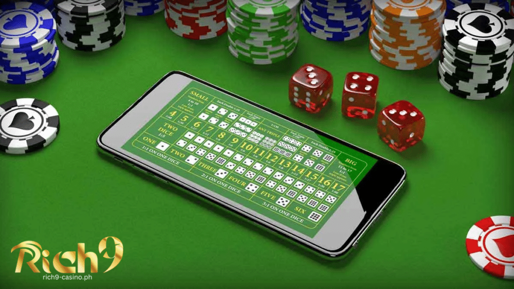 online sic bo in mobile phone with physical chips and dice around it