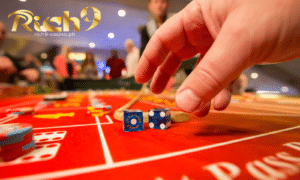 craps table with chips on different types of bets and the is being roll by a casino dealer